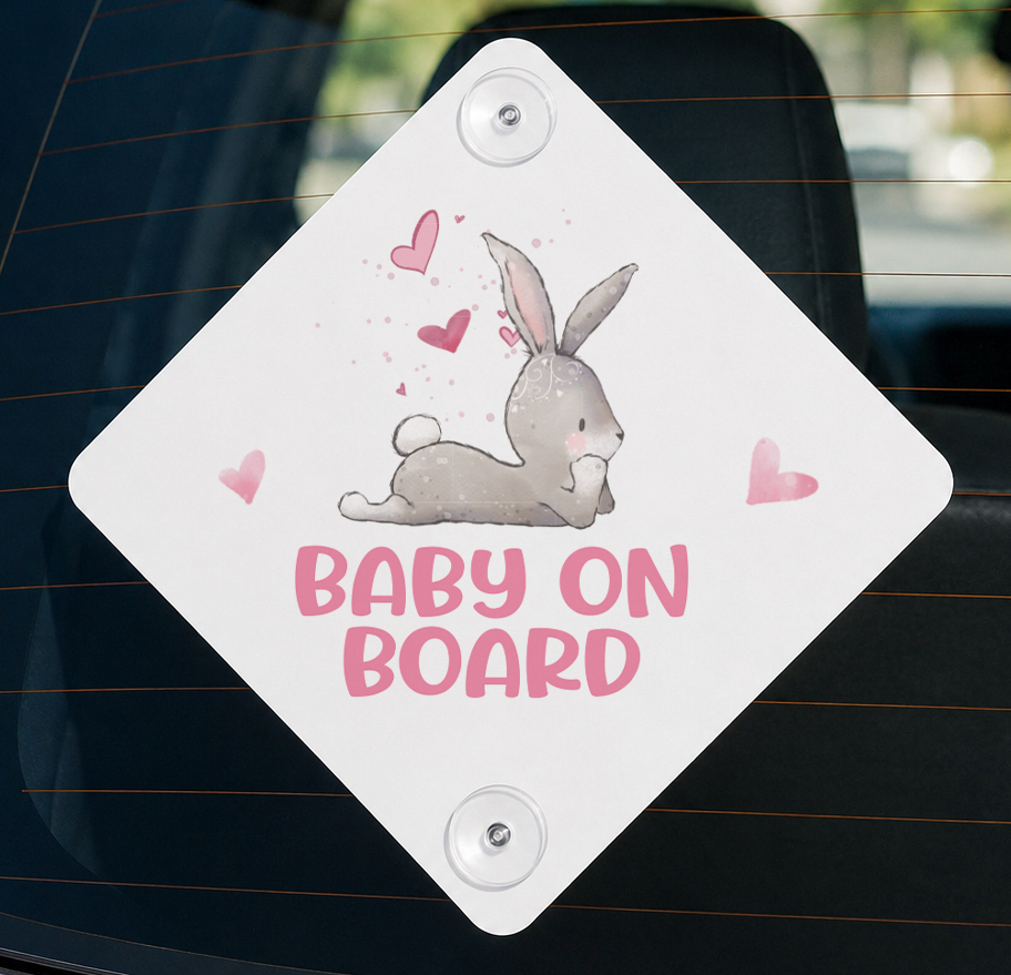 White diamond-shaped aluminium Baby on Board car window sign with a cartoon bunny rabbit design