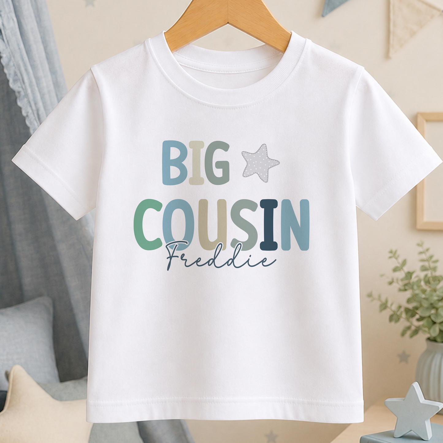 A white t-shirt with the text "BIG COUSIN Freddie" printed on it.