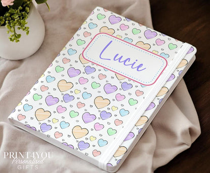 Personalised A5 heart notebook with pastel rainbow hearts and custom name on cream PU leather cover