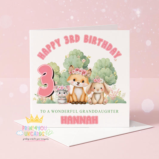 Personalised birthday card showing a woodland scene with a bunny and fox wearing floral crowns, with space for a custom name and age
