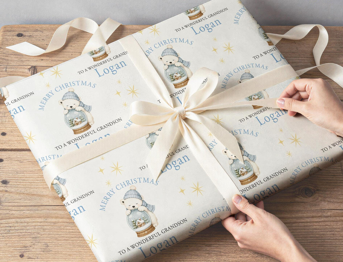 Personalised polar bear snow globe wrapping paper wrapped around a gift box under the Christmas tree.