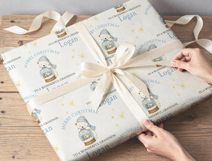 Personalised polar bear snow globe wrapping paper wrapped around a gift box under the Christmas tree.