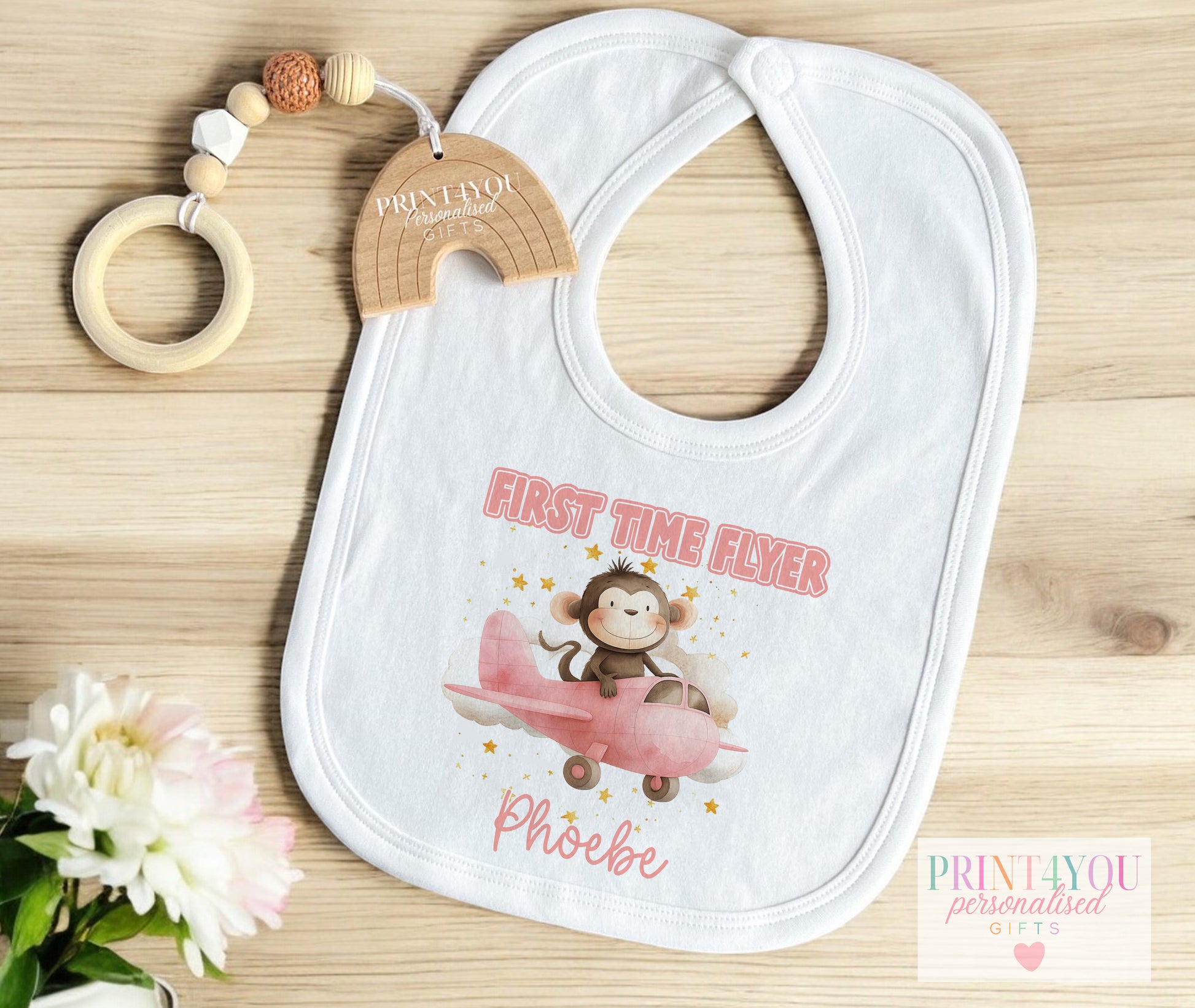 Personalised first time flyer baby bib with a monkey in an aeroplane design and hook-and-loop fastening