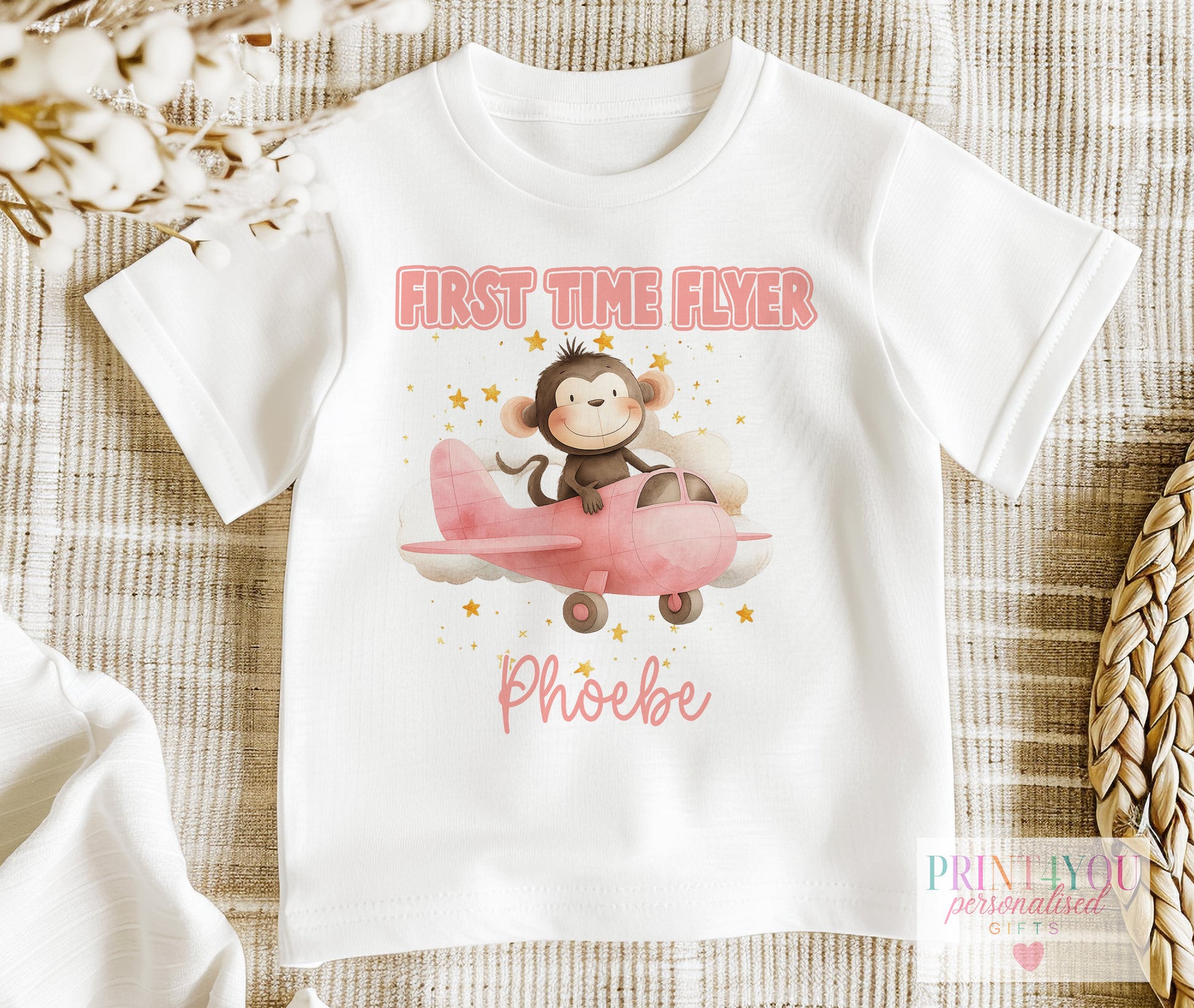 Personalised first time flyer baby t-shirt with a monkey in an aeroplane design and the child's name