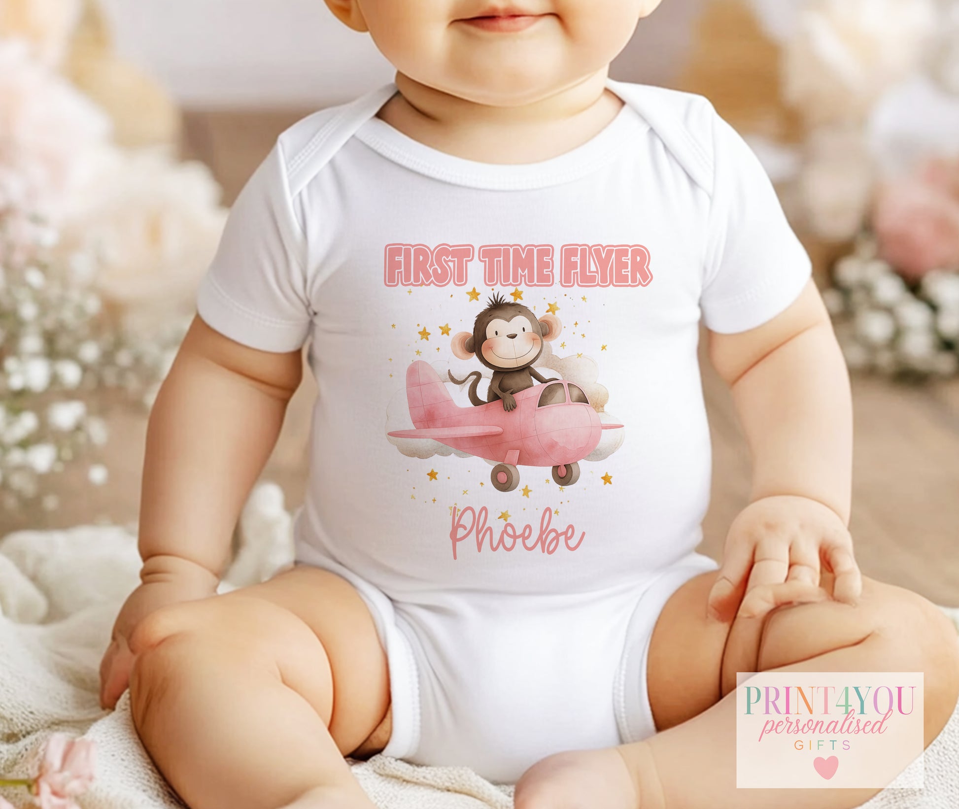 Personalised first time flyer baby vest with a monkey in an aeroplane design
