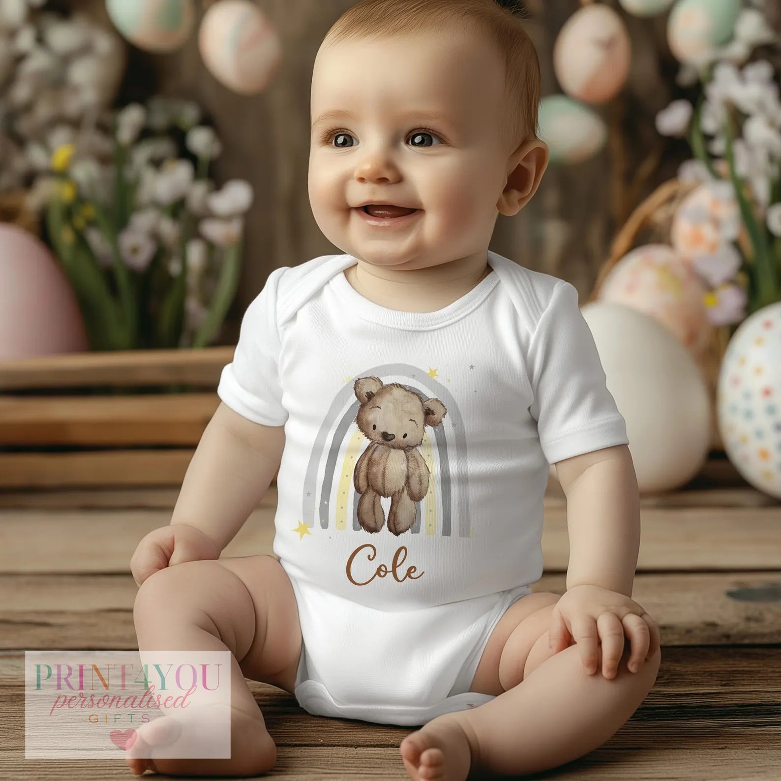 Personalised teddy bear and rainbow baby vest, custom printed with the baby's name.