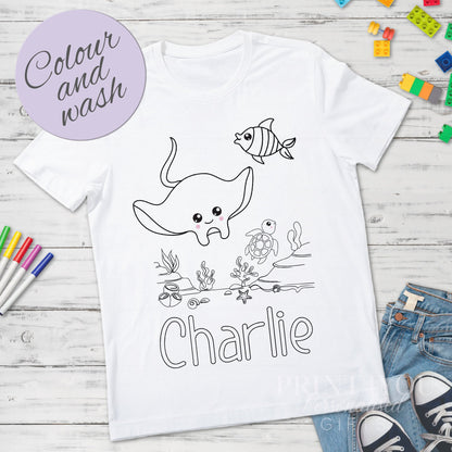 Close-up of the manta ray colour-in outline design and custom name on a kids personalised t-shirt