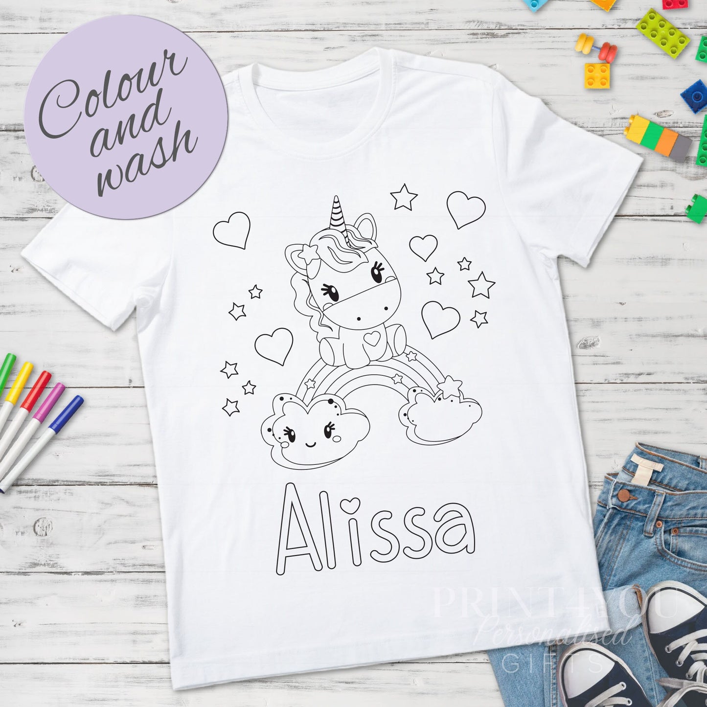 Personalised unicorn colour-in t-shirt laid flat showing washable outline design, size 1-2 years