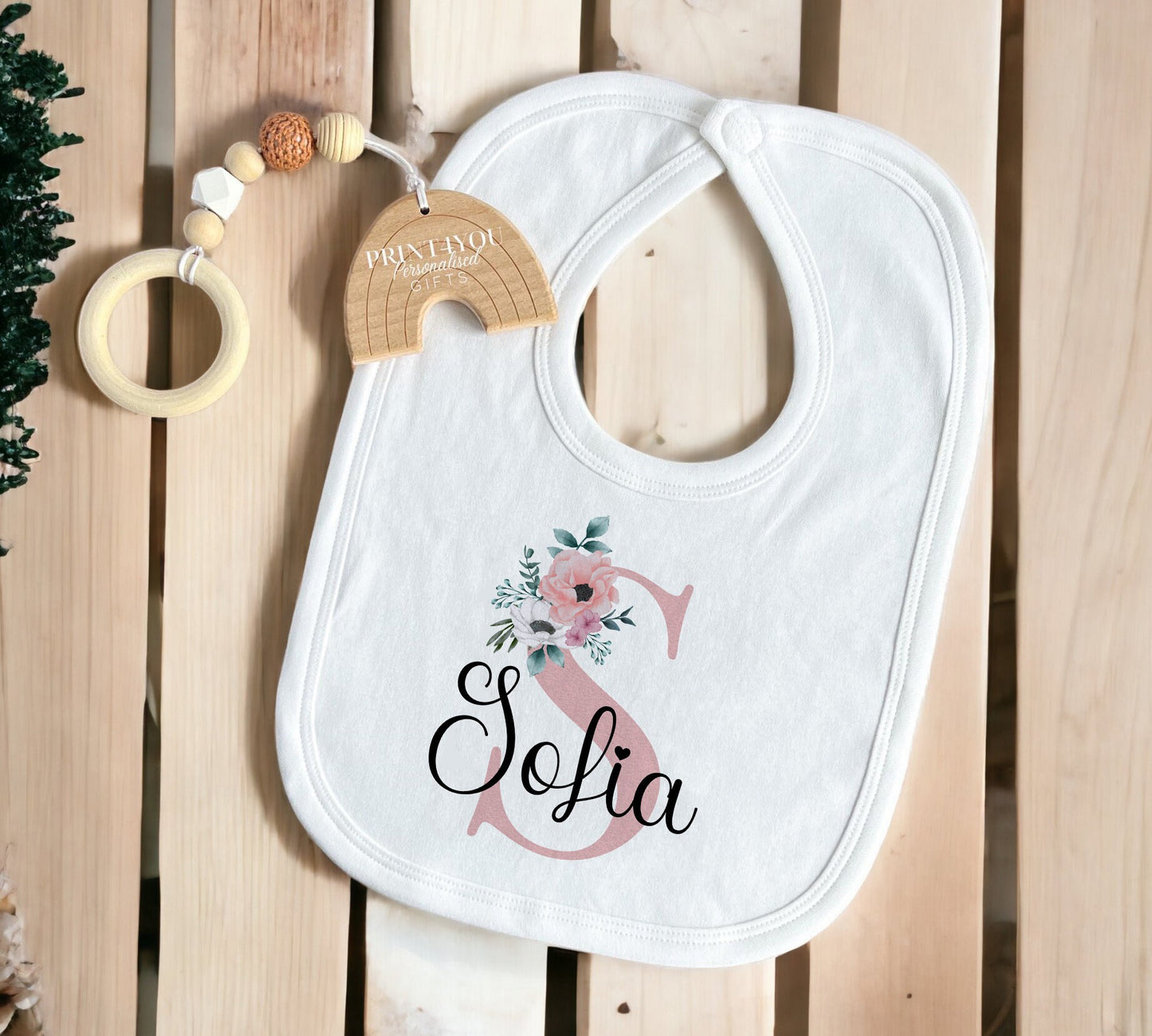Close-up of the pink floral personalised print detail on the Baby Girl Sleepsuit