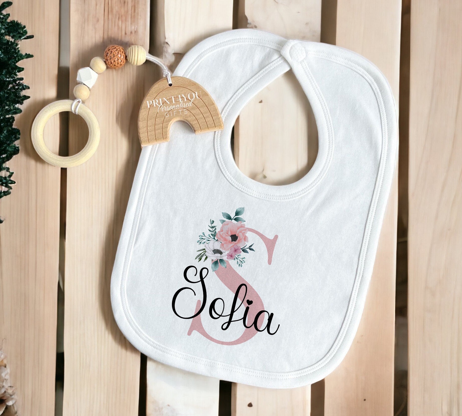 Close-up of the pink floral personalised print detail on the Baby Girl Sleepsuit