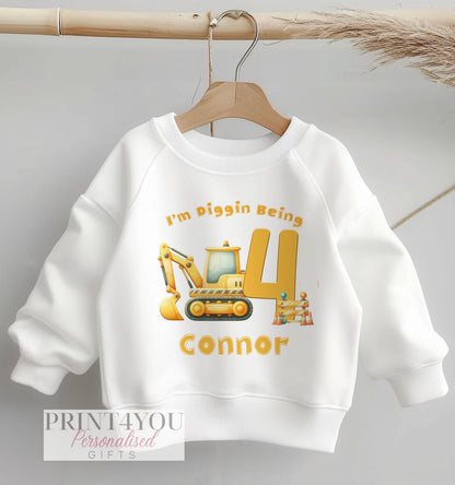 Personalised digger birthday jumper with construction site print and custom name, size 6-12 months