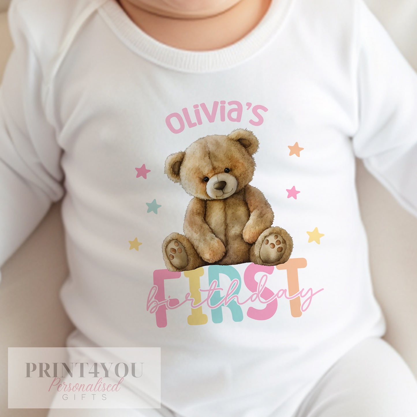 Close-up of the Girls Teddy Bear print and personalised name on the first birthday outfit.