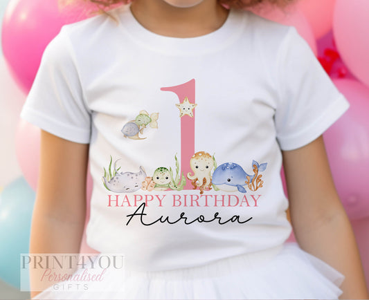 Personalised under the sea baby bib, printed with a child's name and age.
