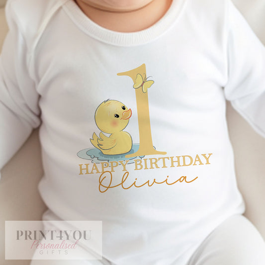 Personalised yellow rubber duck first birthday bib in soft white cotton, printed with your baby's name.