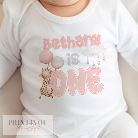 Personalised pink giraffe bib with baby's name printed on soft white cotton.