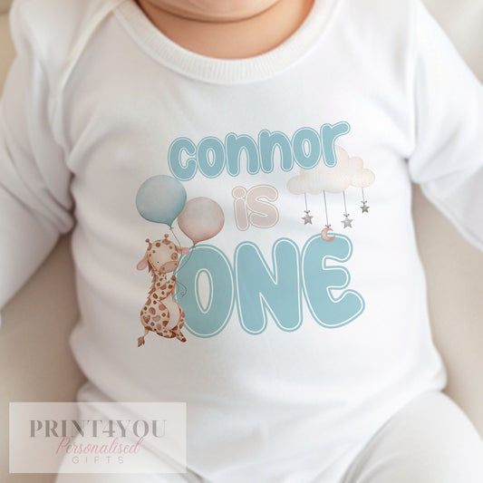 Personalised blue giraffe bib with baby's name printed on soft white cotton.