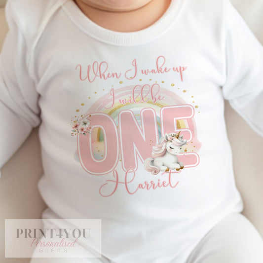 Personalised unicorn and rainbow first birthday bib in soft white cotton, printed with 'When I Wake Up I Will Be One'.