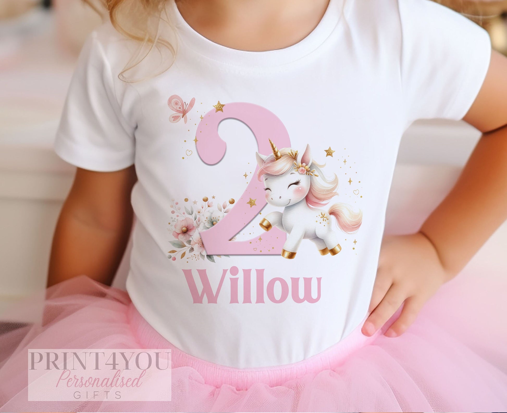 Personalised sparkly unicorn birthday t-shirt in white cotton, printed with your child's name and birthday number.
