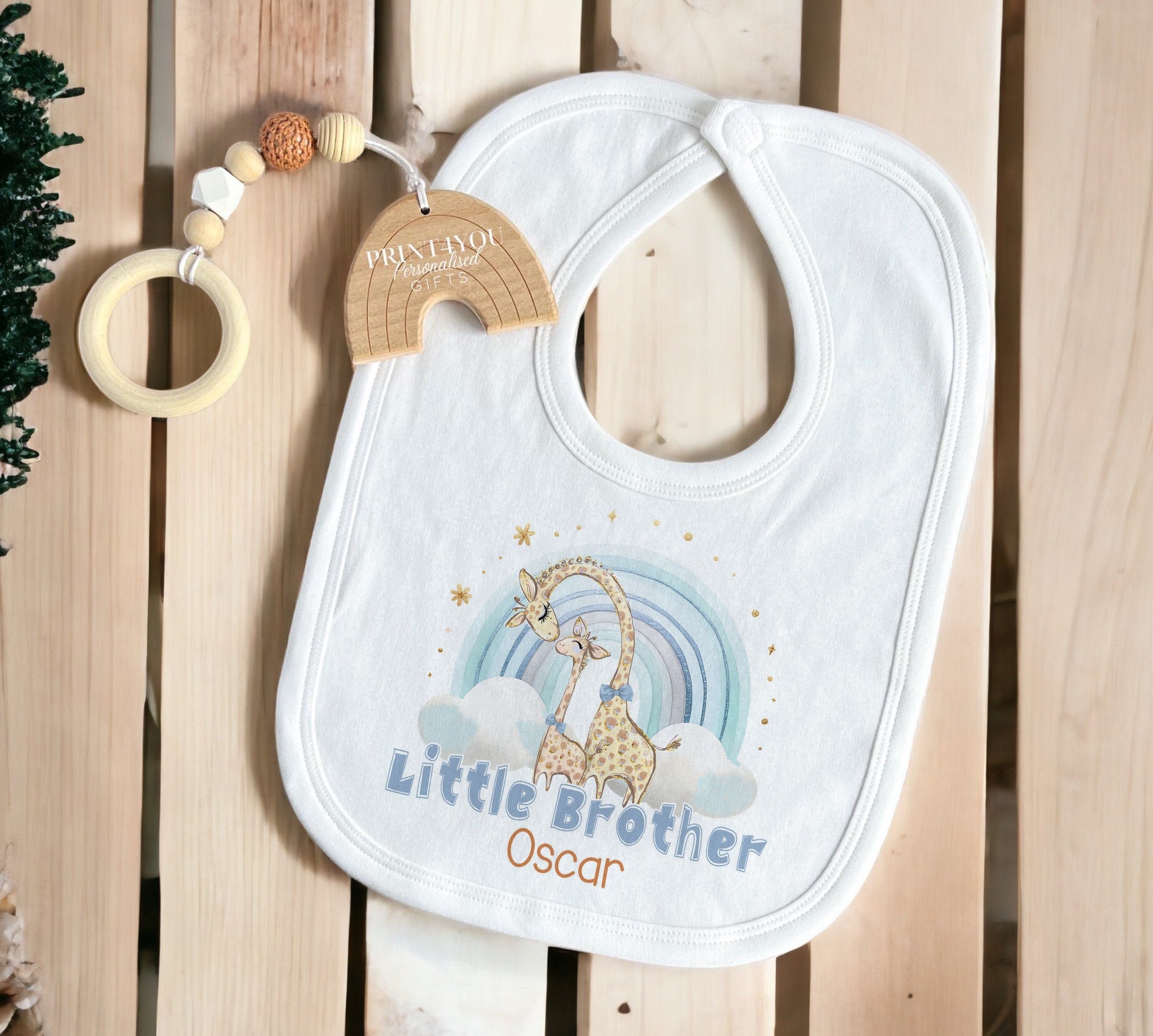 Rainbow giraffe personalised baby outfit styled flat lay
