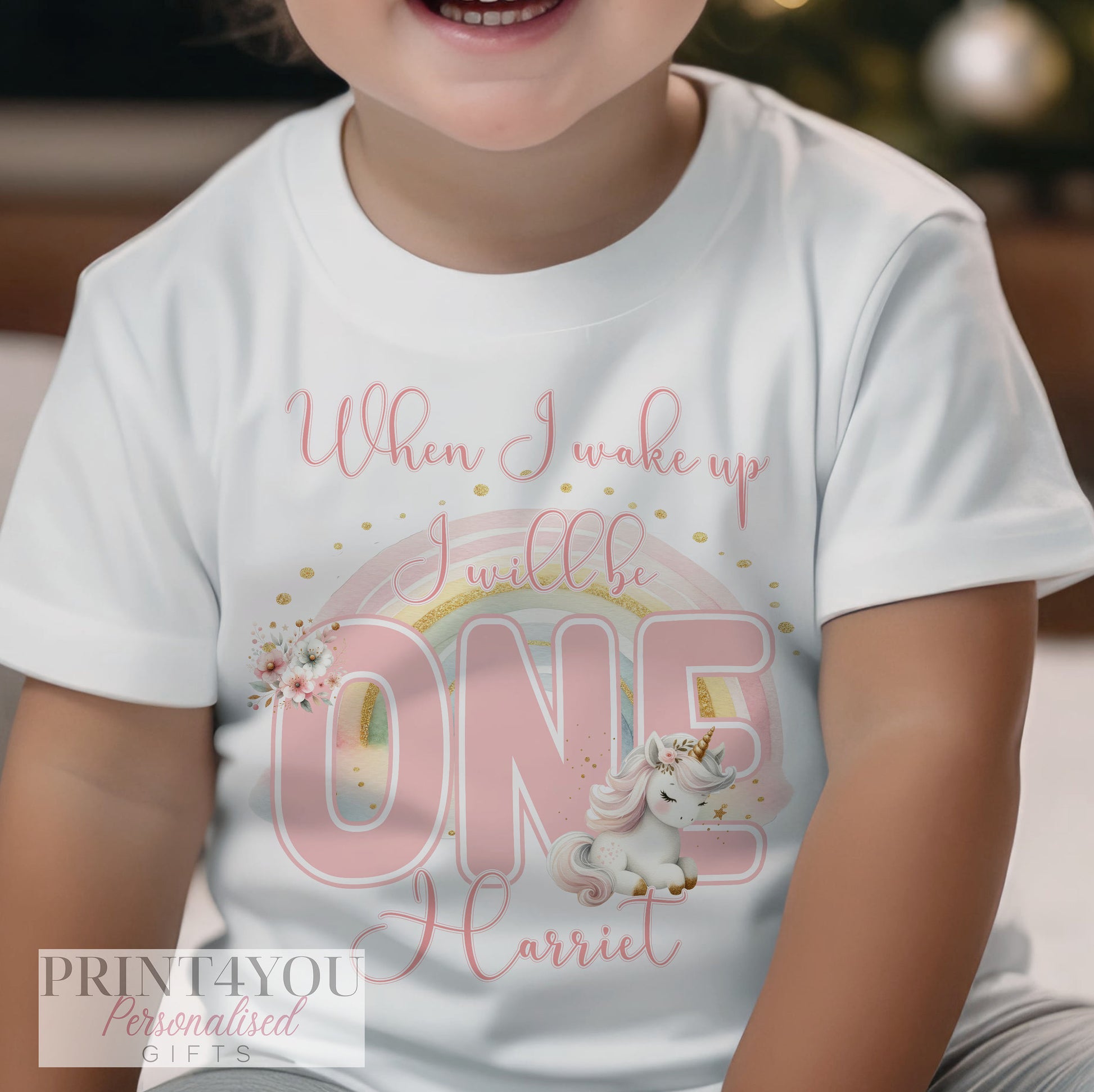 Close-up of the unicorn and rainbow print showing the personalised name detail.