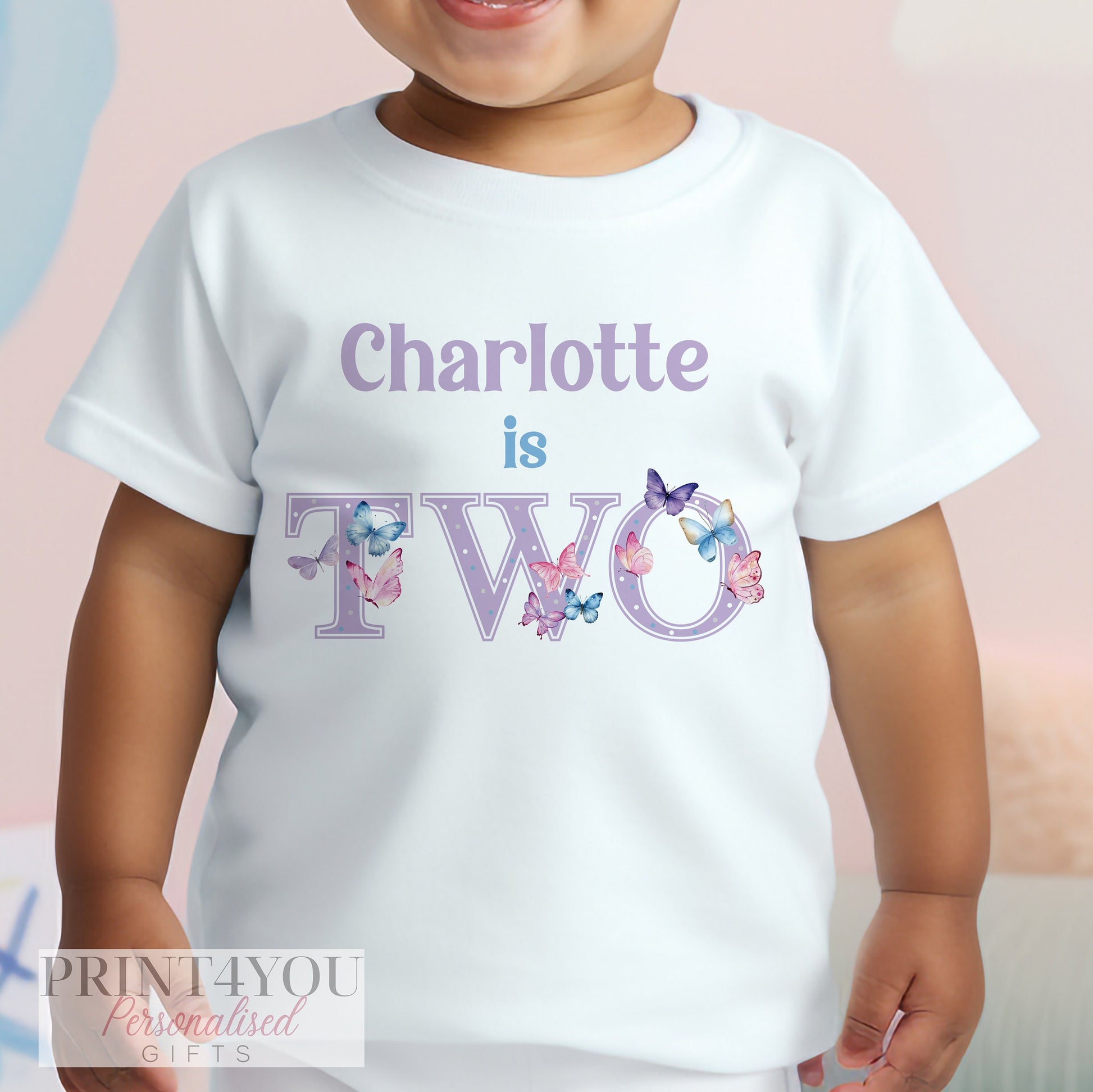 Personalised purple butterfly birthday t-shirt for a girl's second birthday, age 1-2 years, printed with a custom name.