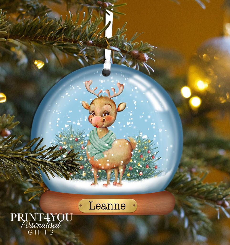 Personalised acrylic Christmas bauble hanging on a Christmas tree branch