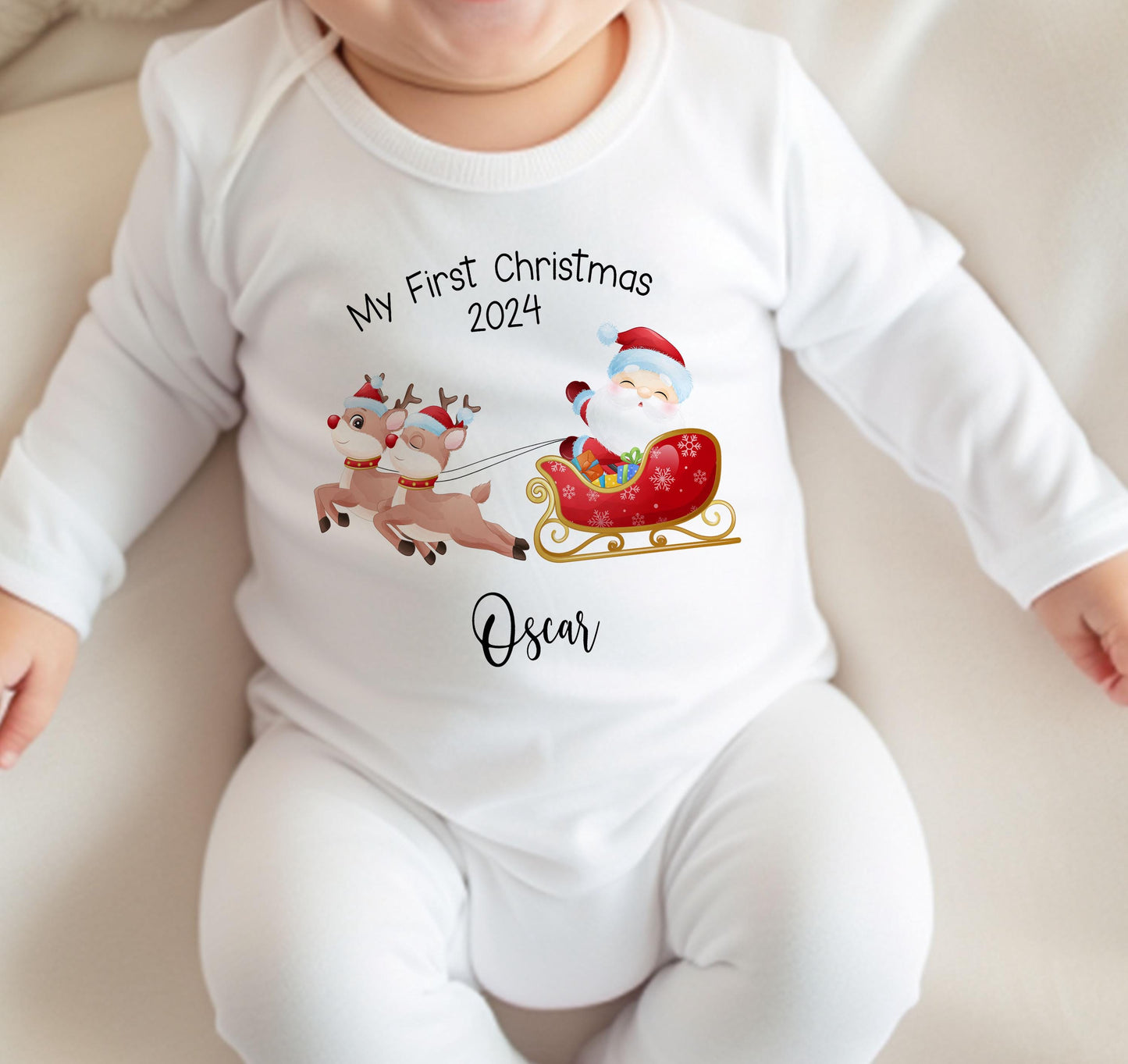 Close-up of the Santa and Reindeer Sleigh first Christmas design personalised with the baby's name.