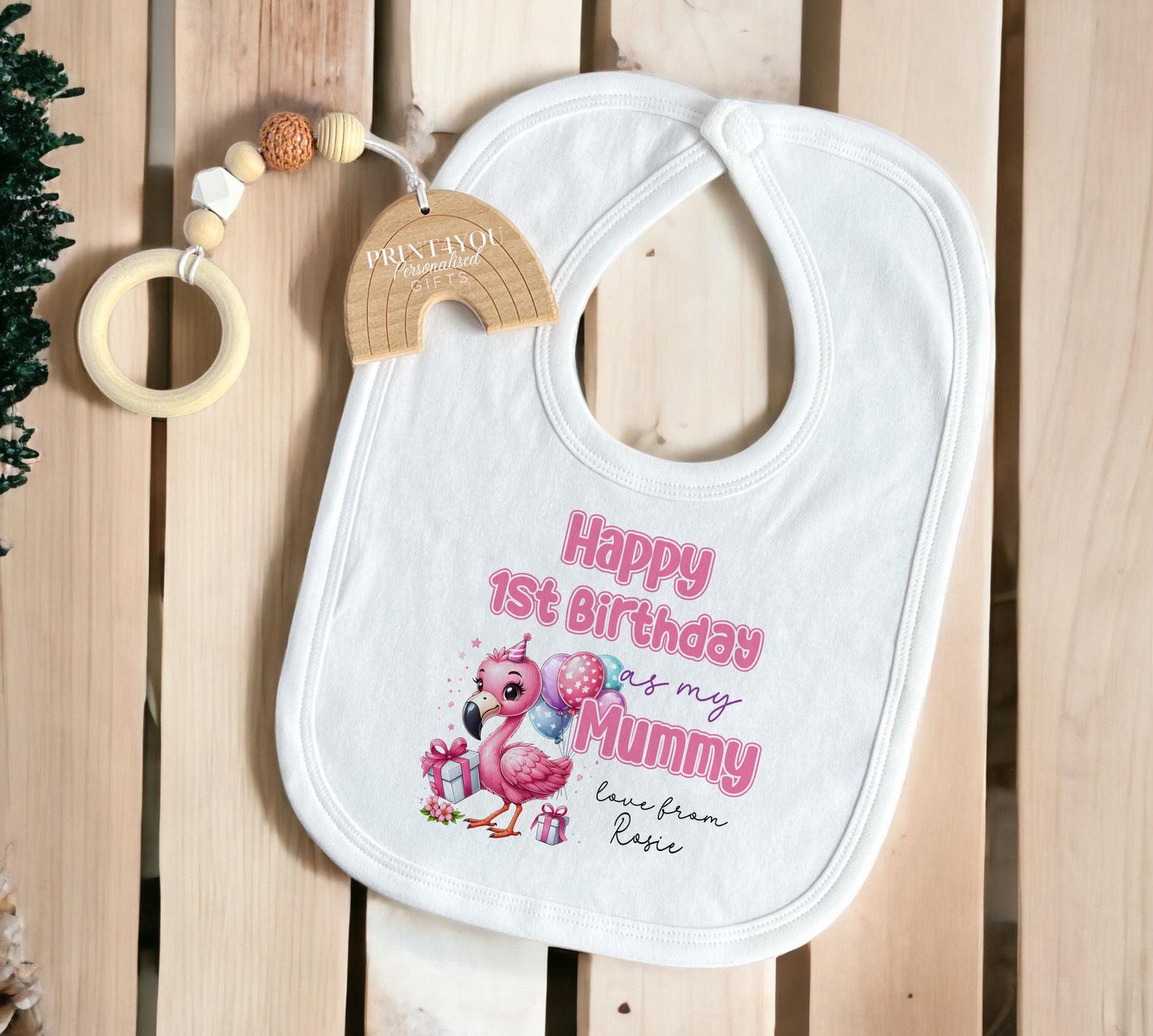 Personalised first birthday baby sleepsuit, folded to show the printed design.