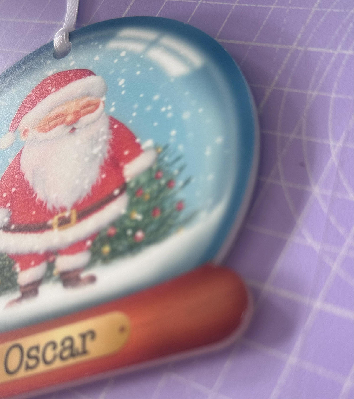 Close-up of personalised acrylic Christmas bauble gift box packaging with ribbon