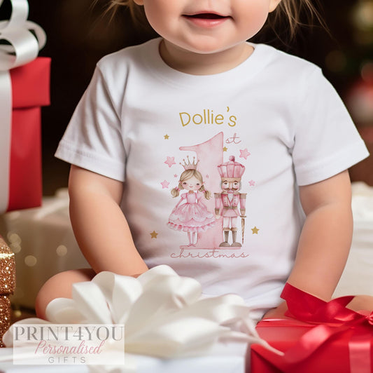 Personalised Pink Nutcracker baby's first Christmas bib, vest and sleepsuit set, folded flat.
