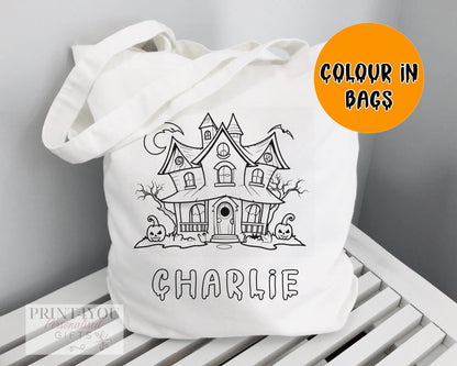 White cotton tote bag printed with a black-and-white haunted house outline, ready to colour in