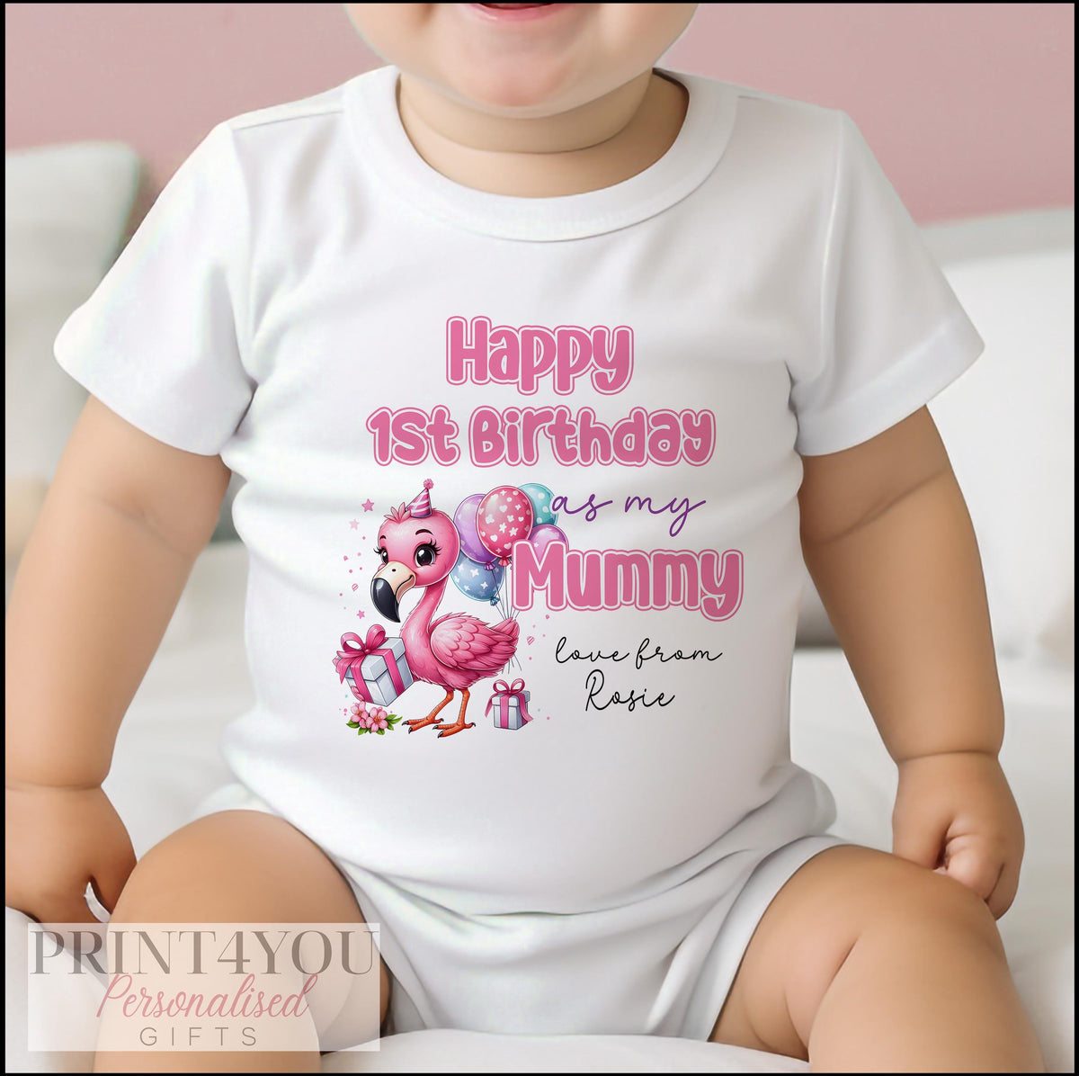 Close-up of the personalised first birthday print on a baby vest or sleepsuit.