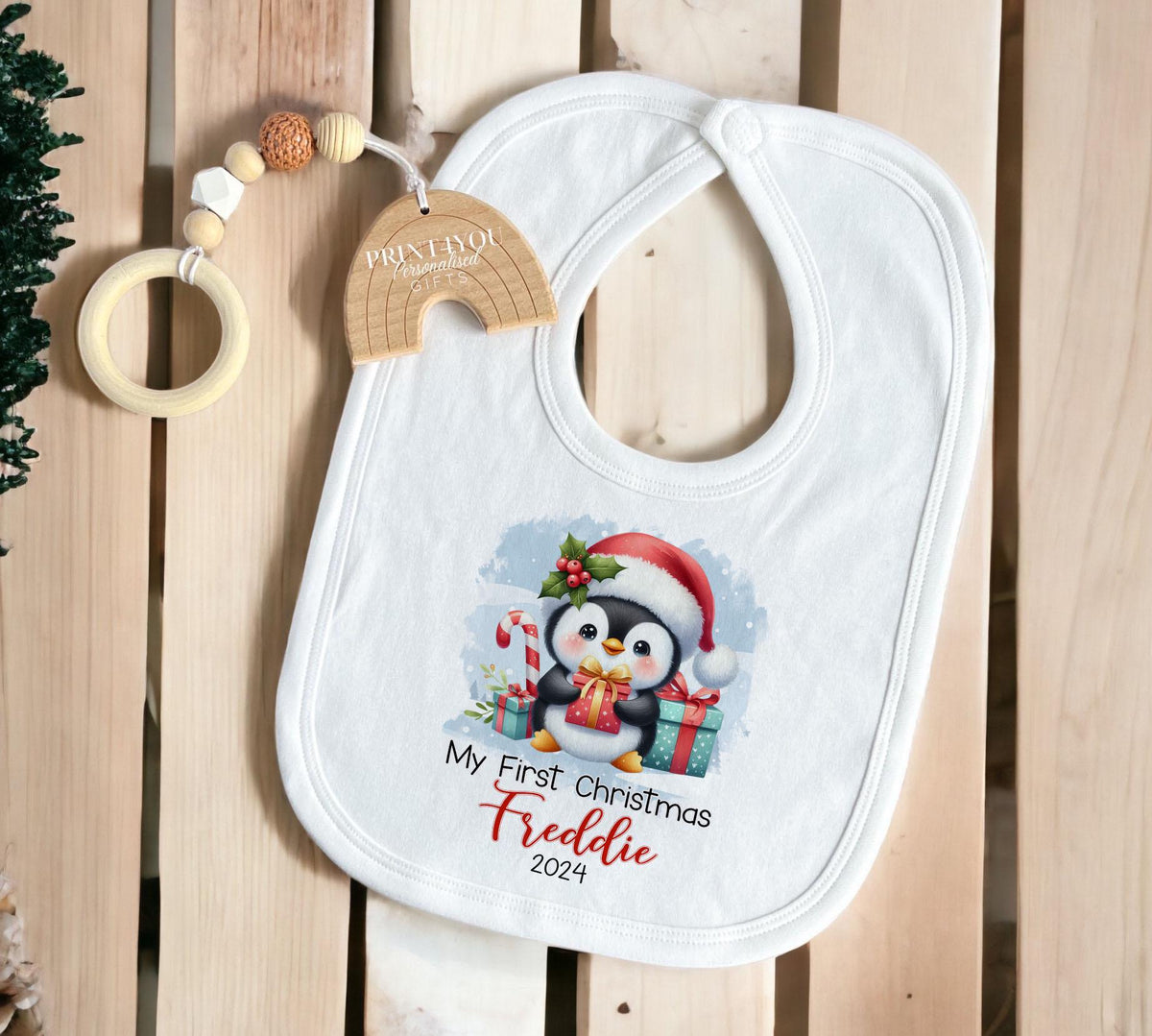 Close-up of the penguin Christmas design personalised with baby's name.