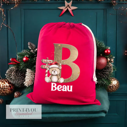 Close-up of the personalised name print on the red Reindeer and Teddy Bear Christmas sack