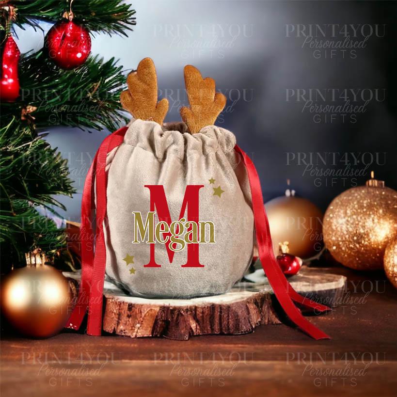 Personalised velvet reindeer Christmas Eve box gift bag filled with festive treats
