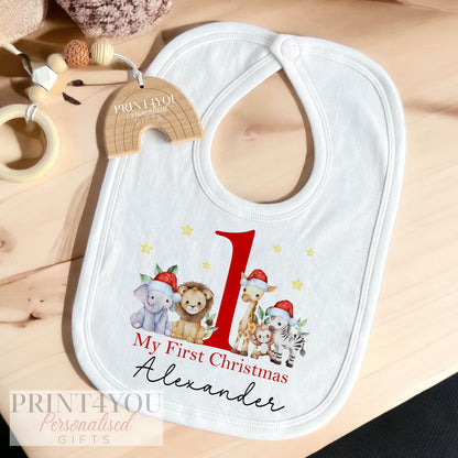 Flat lay of the Baby's First Christmas bib, vest and sleepsuit gift set