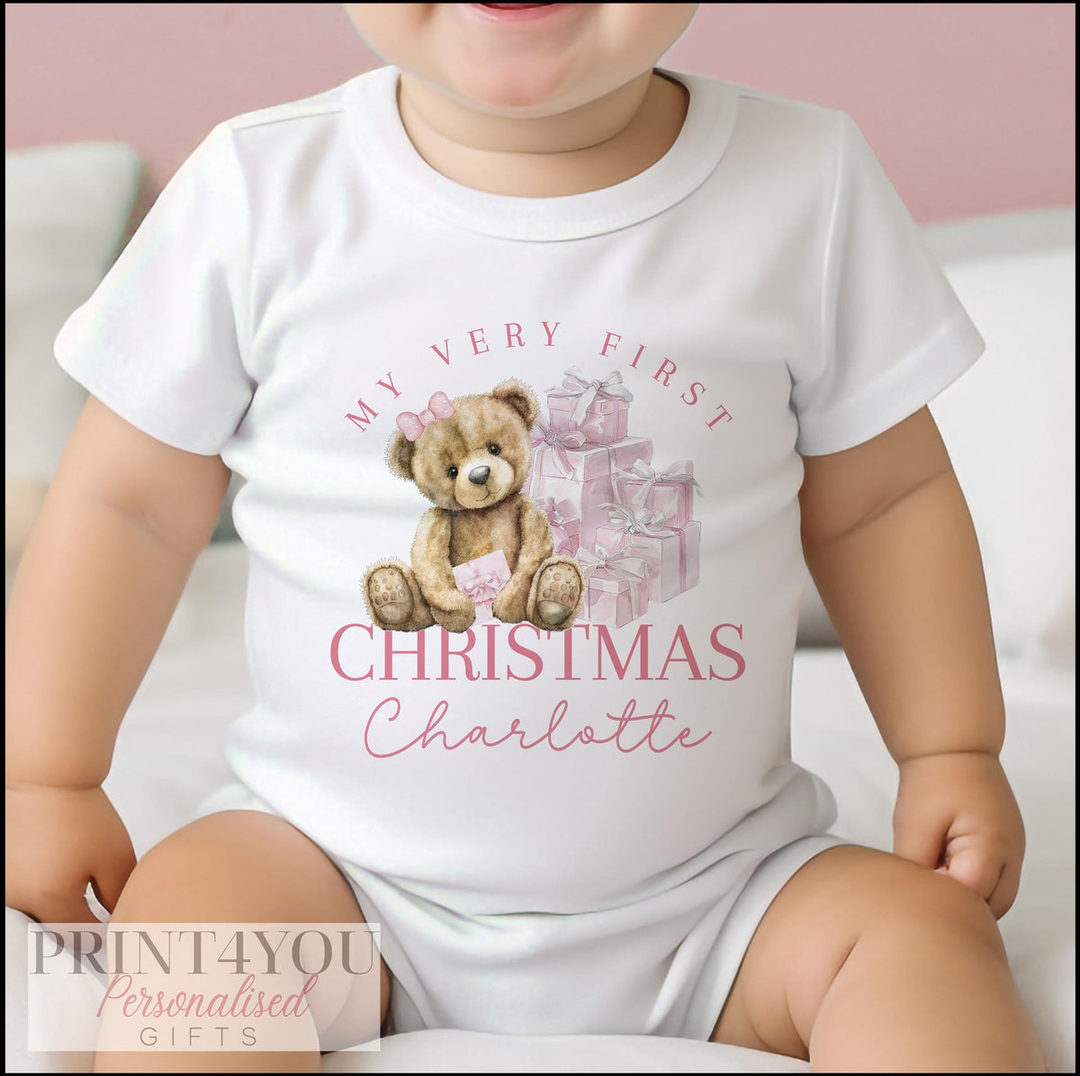 Personalised baby's first Christmas vest laid flat to show the full festive print and sizing.