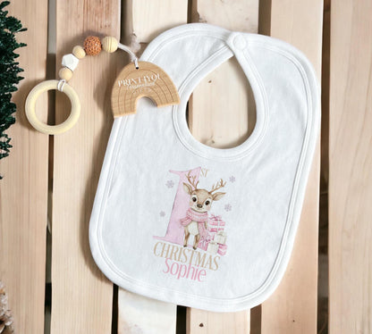 Personalised baby's first Christmas sleepsuit with a pink reindeer design and the baby's name.