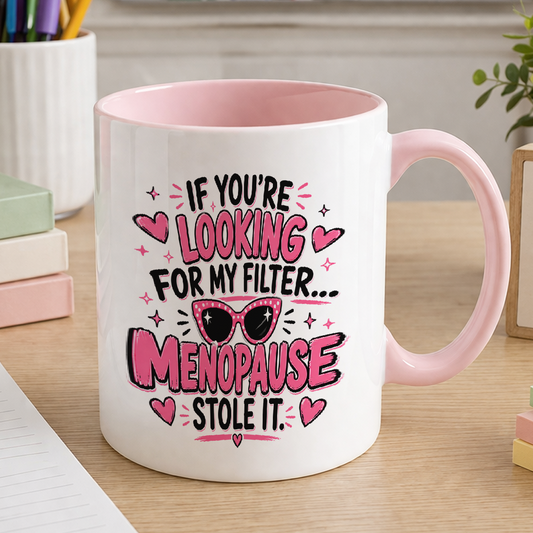 White ceramic mug with pink handle printed with the slogan If you're looking for my filter, menopause stole it