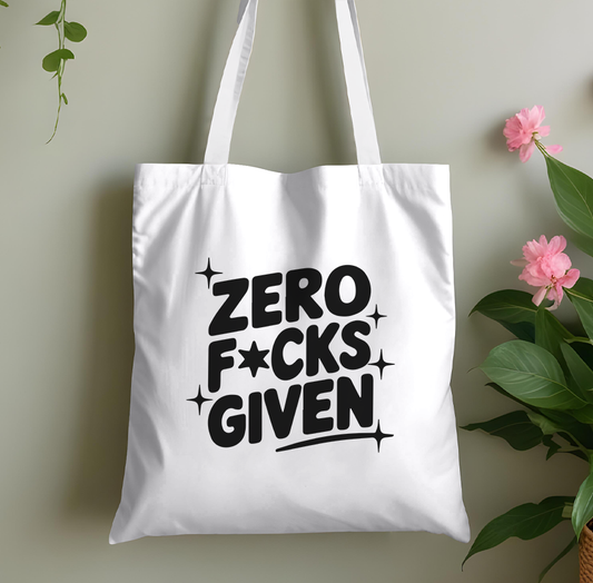Plain pink cotton tote bag printed with a bold 'Zero Fucks Given' adult-humour slogan, laid flat against a plain background