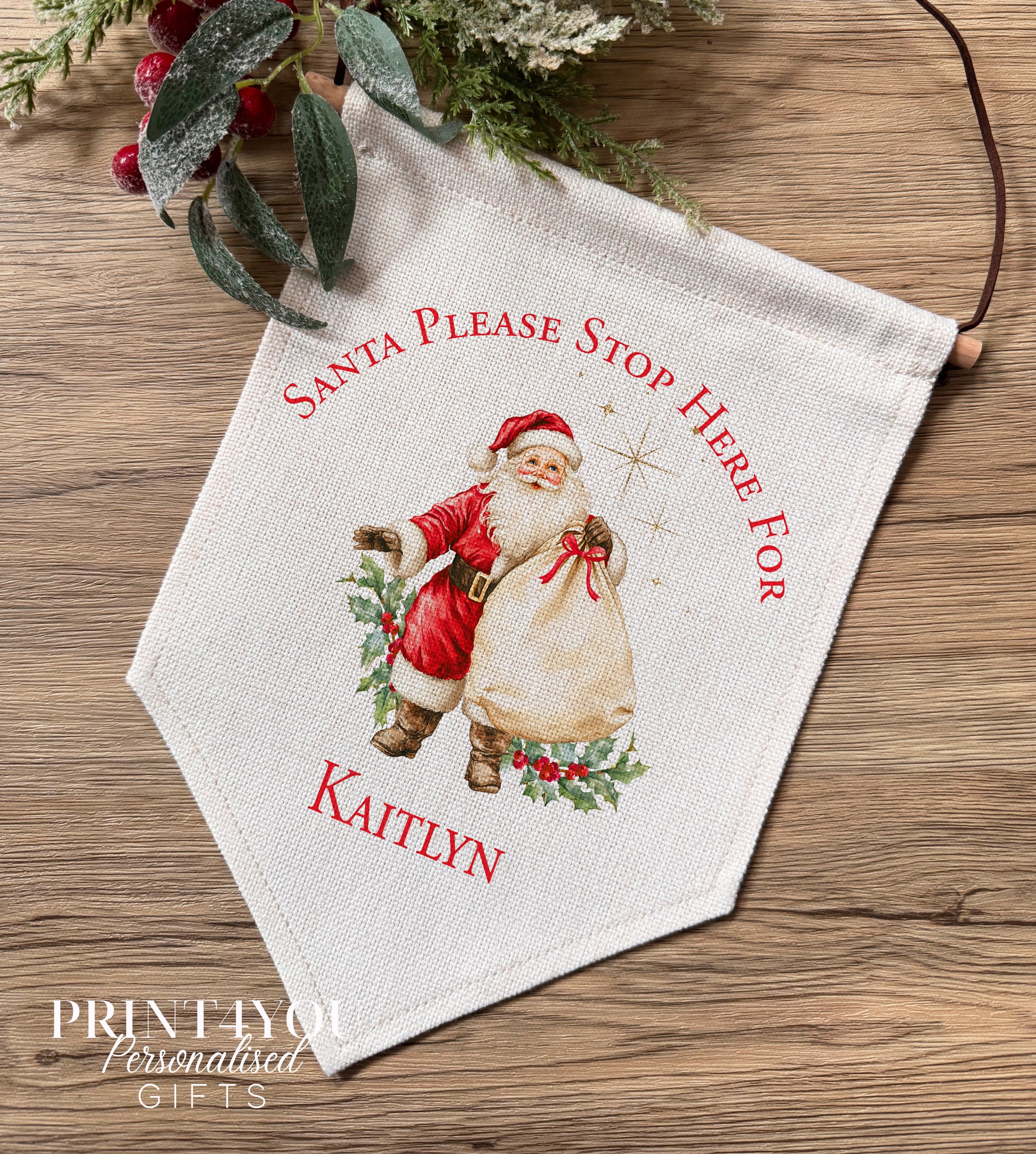 Personalised linen Christmas banner featuring a classic Father Christmas design, personalised with the name Oliver, hung on a wooden bar