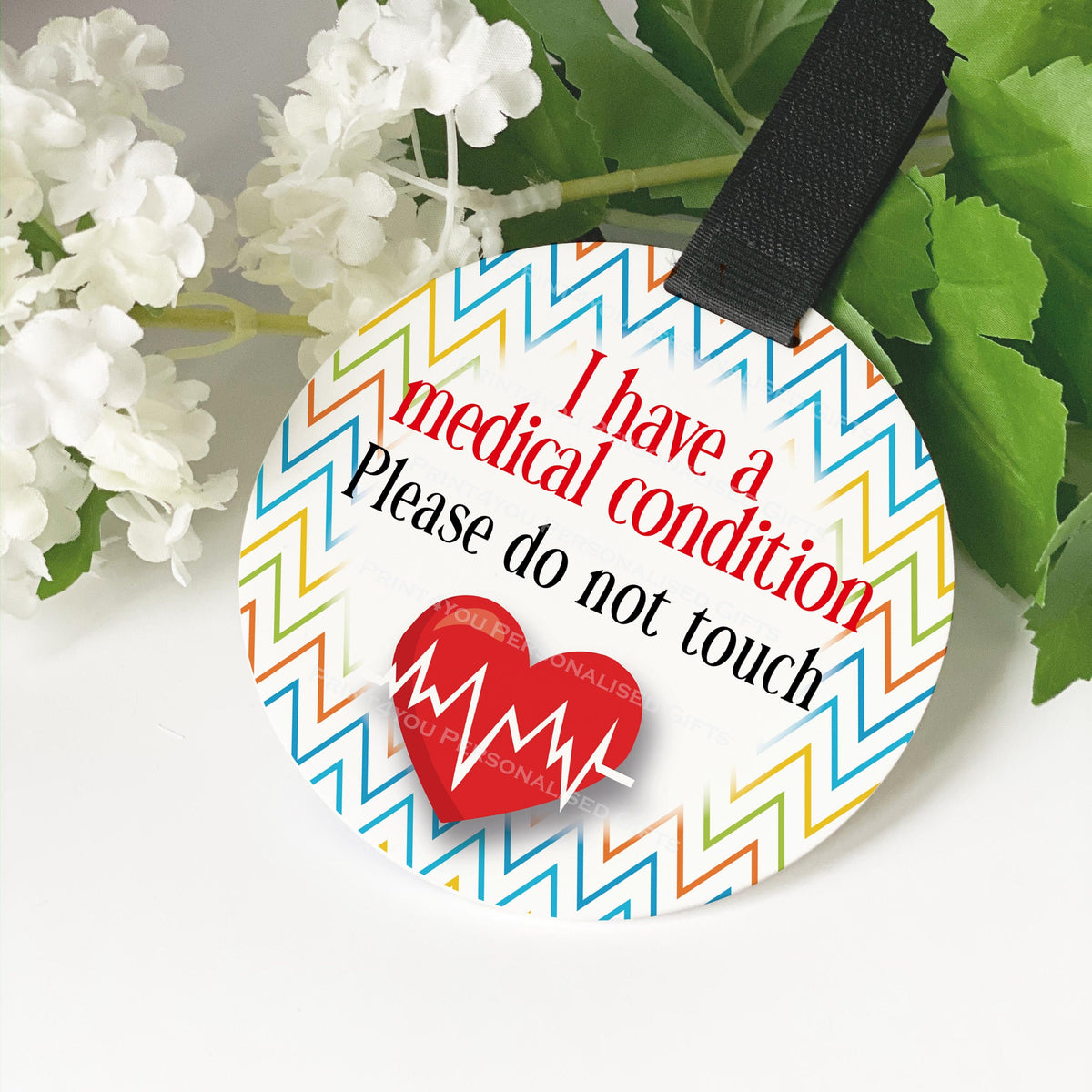 Round acrylic car seat sign reading please don't touch baby, with a black nylon loop fastener strap
