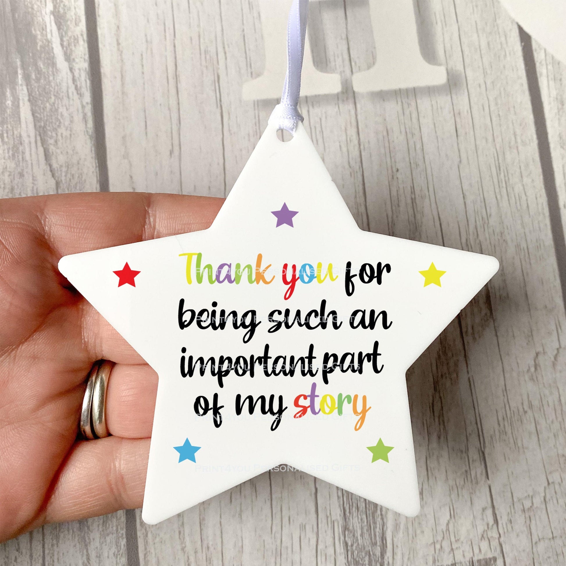 Rainbow star hanging decoration displayed against a plain background.