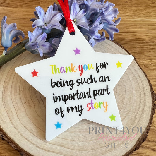 White acrylic star hanging decoration printed with rainbow colours and a thank you message.
