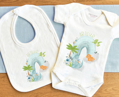 Close-up of the dinosaurs on a rainbow design with personalised name text.