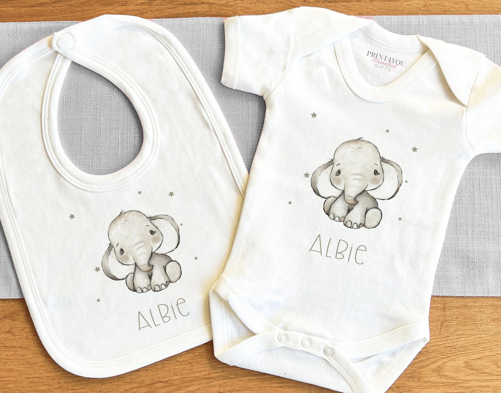 Close-up of the grey baby elephant design and personalised name print on soft cotton.