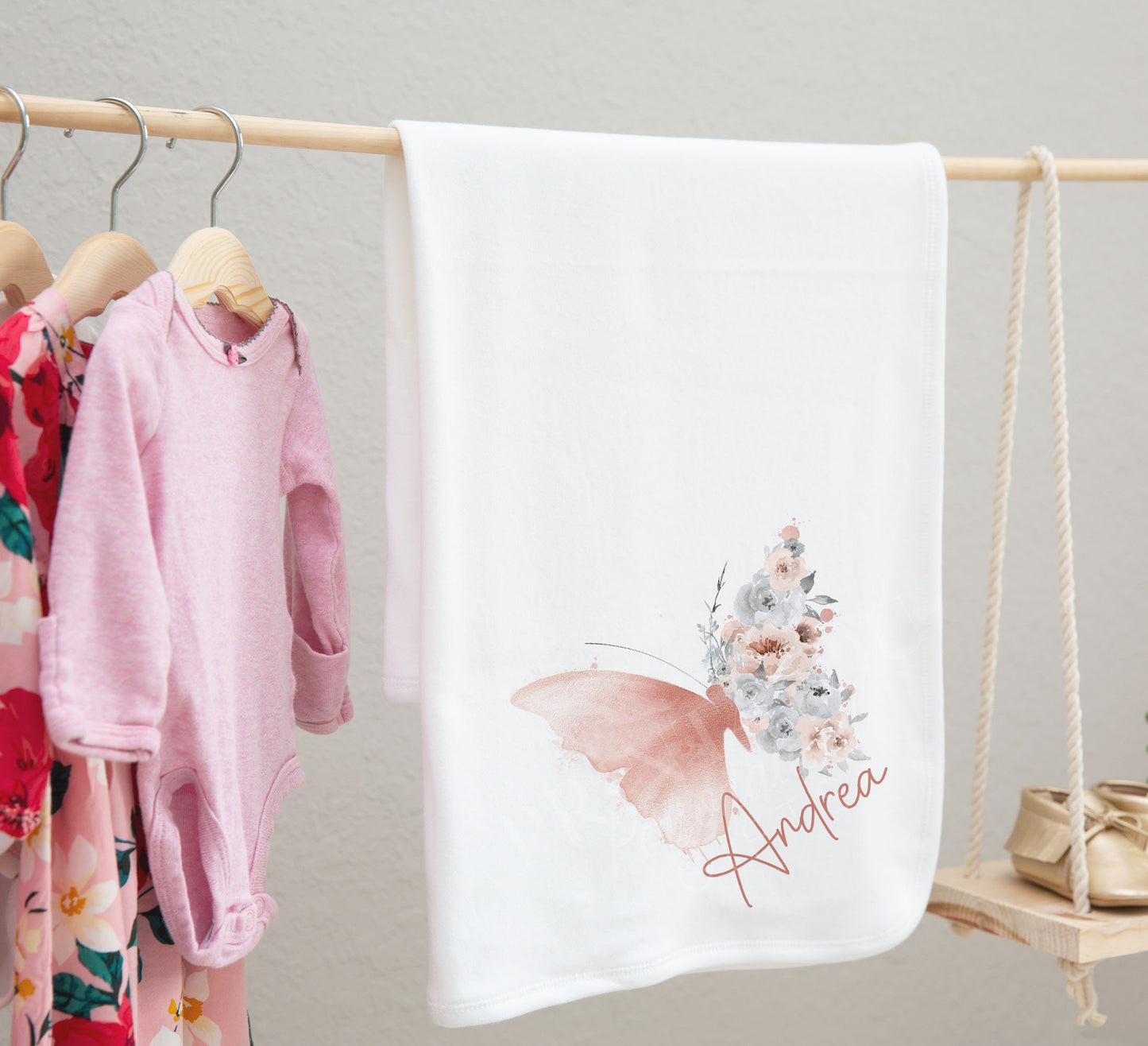 Blush butterfly baby bib styled for a new baby photoshoot.