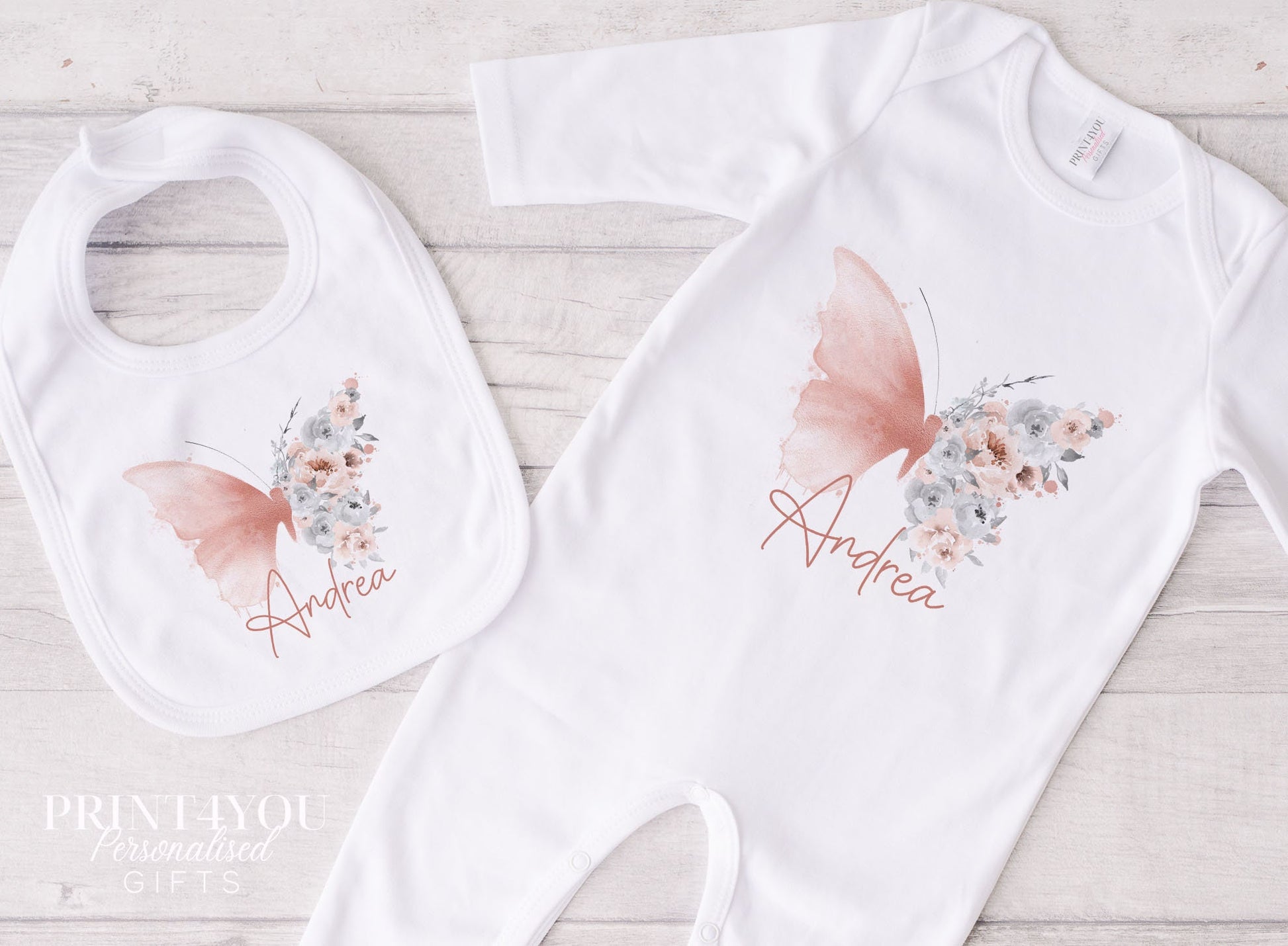 Blush butterfly personalised baby bib laid flat, showing the popper fastening.