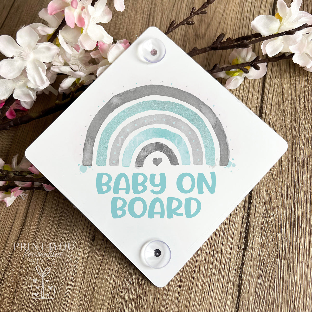 Rainbow Baby on Board aluminium car window sign fitted with suction cups on a car window