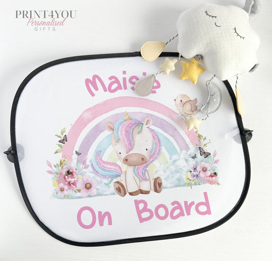 Personalised car window sun shade printed with a unicorn and rainbow design and baby on board wording, fitted with suction cups